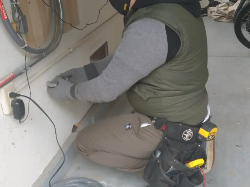 Electrician performing outlet wiring in a Lake Hallie garage