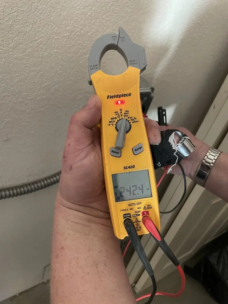 Voltage testing with clamp meter during Recessed Lighting Installation in Lake Hallie